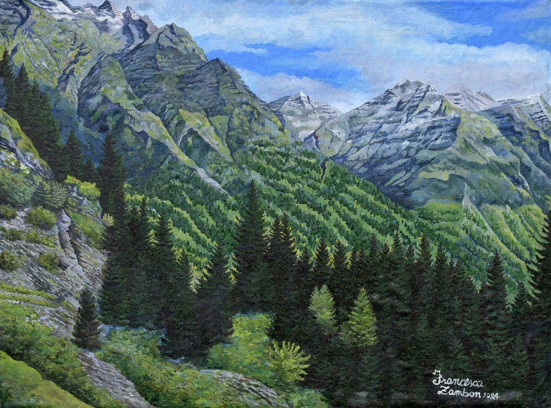An oil painting that shows tall, jagged mountains covered with green vegetation and patches of gray rock. Some peaks in the background are dusted with snow. The lower portion of the painting is filled with a dense forest of dark evergreen trees, with lighter green foliage interspersed in places. The sky above is partly cloudy with patches of bright blue. The artist’s signature, Francesca Zambon 2024, appears in the bottom right corner.